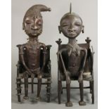 Pair of Yoruba metal figures, female and male, each naturalistically depicted seated in throne