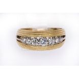 Diamond and 14k gold band ring featuring (7) full cut diamonds weighing a total of approximately 0.