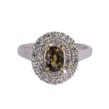 Andradite garnet, diamond and 14k white gold ring centering (1) oval andradite garnet weighing