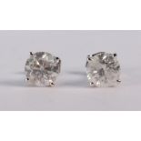 Pair of diamond and 14k white gold stud earrings featuring (2) round brilliant cut diamonds weighing