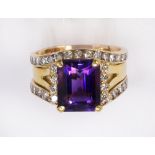 Amethyst, diamond and 14k yellow gold ring featuring one emerald-cut amethyst weighing approximately