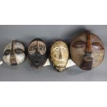 (lot of 4) Luba and Songe, D.R. Congo style decorative carved wood masks, including a Andre Derain