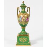 Austrian polychrome decorated porcelain lidded urn, having a Classical style form, with partial gilt