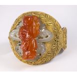 Large carnelian, serpentine, silver and gilt bracelet featuring a carved carnelian plaque, measuring