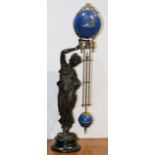 Classical style pewter finished figural mystery clock set with a beauty and a blue enameled globe