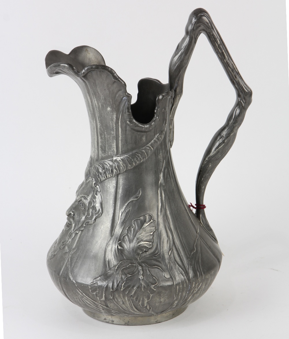 Art Nouveau figural pitcher, executed in molded pewter, depicting the head of a horned mystical