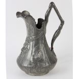 Art Nouveau figural pitcher, executed in molded pewter, depicting the head of a horned mystical