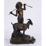 Continental patinated bronze figural sculpture of a young boy and a goat, in a naturalistic setting,