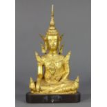 Thai gilt bronze Buddha, orantely adorned and in bhumispharsa (earth witness) mudra, on wood