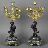 Pair of Clodion style bronze, marble, and gilt metal candelabra, each having five lights surmounting