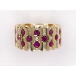 Ruby, diamond and 14k yellow gold ring featuring (14) round-cut rubies, weighing approximately 1.