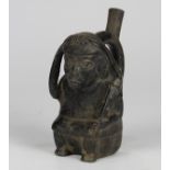 Pre-Columbian Chimu blackware spout stirrup vessel, 1050 to 1450 CE, depicting a seated warrior