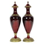 Pair of French Louis XV style enamel decorated urns, each having a Classical style form in deep