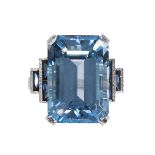 Blue topaz, synthetic sapphire, diamond and platinum ring featuring (1) emerald-cut blue topaz,