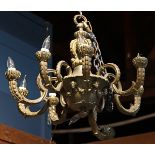 Patinated bronze chandelier in the Neo-classical taste, having a beaded ring above a standard with