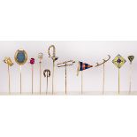 (Lot of 11) Multi-stone, yellow gold stick pins comprised of one enamel, 14k yellow gold flag