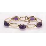 Amethyst and 14k yellow gold bracelet featuring (5) carved amethyst scarabs, measuring approximately