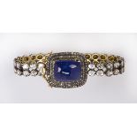 Tanzanite, diamond, 14k yellow gold and sterling silver bracelet highlighted by a large 14k yellow