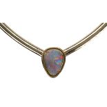 Opal and 14k yellow gold necklace featuring one irregular pear shaped flat opal cabochon,