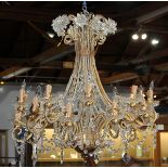 Crystal and partial gilt chandelier, the tiered form having (21) lights with floral reserves