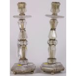 Pair of rock crystal candlesticks, each having a single light above a faceted bulbous carved stone