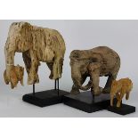 (Lot of 3) Carved wood elephant form figural group, each rising on a custom black plinth, 13"h x