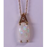 Opal, diamond and 14k yellow gold pendant-necklace featuring (1) oval cabochon, measuring