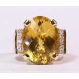 Citrine, diamond and 14k yellow gold ring featuring (1) oval faceted topped citrine, measuring