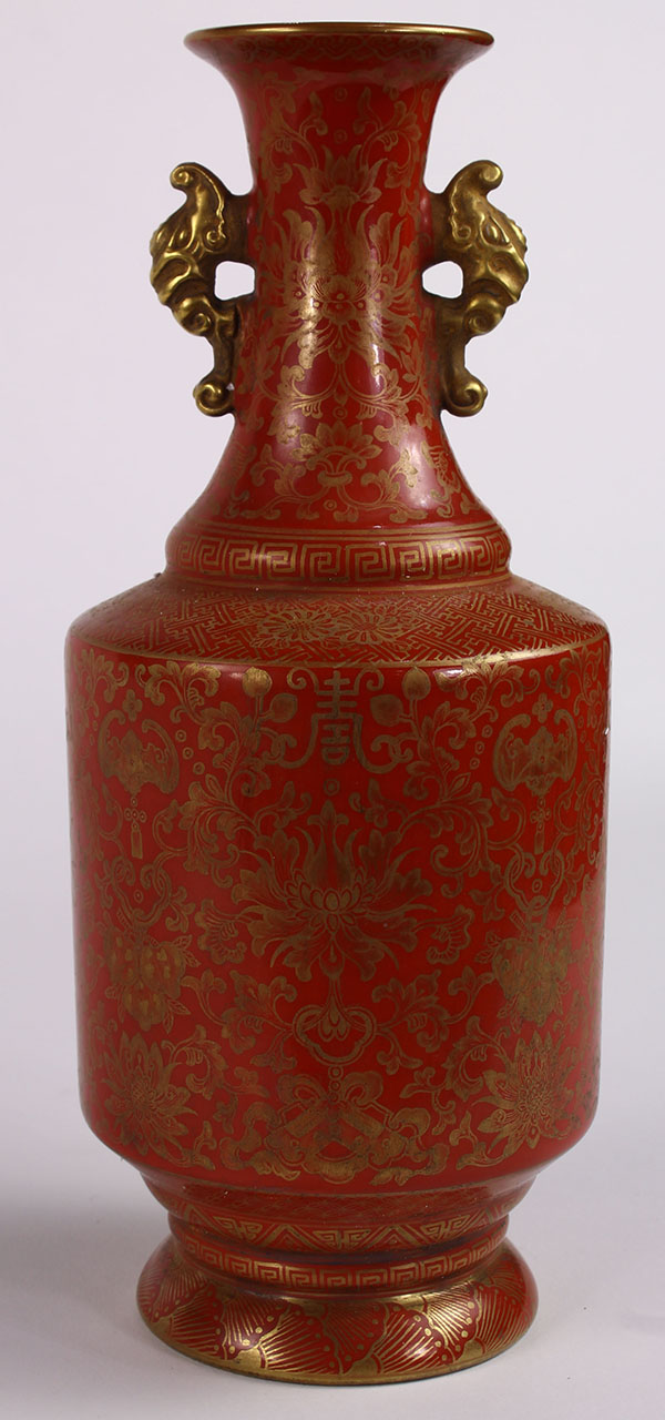 Chinese gilt coral hue porcelain vase, the trumpet neck flanked by elephant supports, and the body