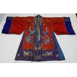 Chinese theathrical robe, with blue dragons on a red ground with gilt couched clouds and flowers,