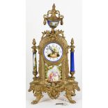 French Neo-Classical style mantle clock fronted by an enameld dial centered with a landscape