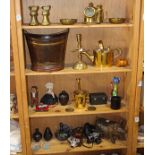 Four shelves of brass nautical and apothicary articles, including weights, candlesticks, a mortar