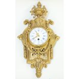 Gilt bronze wall clock in the Neoclassical taste, having an urn finial above a pierced plaque with