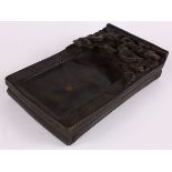 Chinese rectangular ink stone, with a pair of meandering dragons above a shallow well 10"l