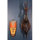 (lot of 2) West African decorative carved masks including an Ivory Coast style surmounted by a