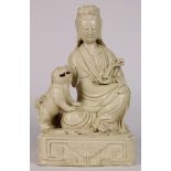 Chinese blanc de chine porcelain Guanyin, seated and holding a ruyi scepter, accompanied by a fu-