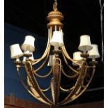 Hollywood Regency eight light chandelier, the large form having a patinated body supporting the