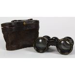 Vintage opera glasses covered in black leather, with leather case