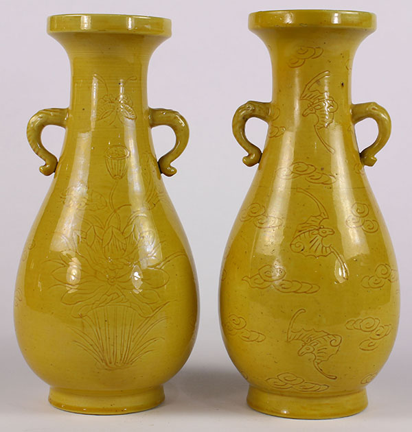 Pair of Chinese yellow glazed porcelain vases, with a dish rim and elephant form handles above a