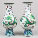 Pair of Chinese doucai porcelain bottle vases, each yuchunping decorated with a green dragon, the