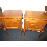 A pair of oak bed side cabinets