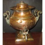 A 19th century copper hot water urn with decorative scroll handles