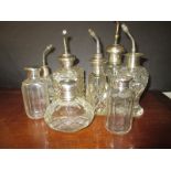 An assortment of silver topped scent bottles and dressing table bottles