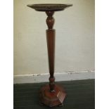 An early 20th century plant stand with hexagonal column