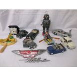 A qty of toys to include tinplate and an Austin Healey 3000 Mk III car badge