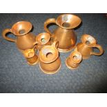 A set of vintage copper measuring jugs