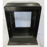 An ebonised glazed door counter top display cabinet