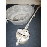 A galvanised bath tub and watering can