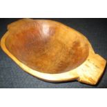 A hand carved wood dough bowl