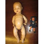 An early 20th century composite doll and one other